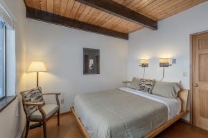 a bedroom with a bed and a chair in it at Icicle Chalet cabin in Leavenworth