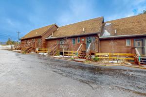 a large log cabin with a road in front of it at Sans Souci in McHenry