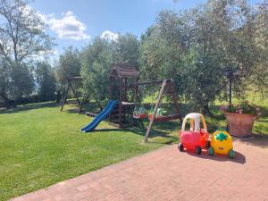 a playground with a toy car and a swing at Agriturismo Corte in Poggio in Stabbia