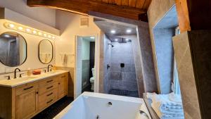 a bathroom with a tub and a sink and a shower at Coalition Lodge in Park City +47 photos