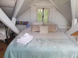 a bedroom with a large bed in a attic at Villa Acacia in Vallauris