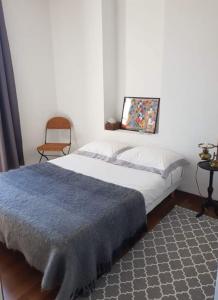 a bedroom with a bed and a painting on the wall at Villa Acacia in Vallauris