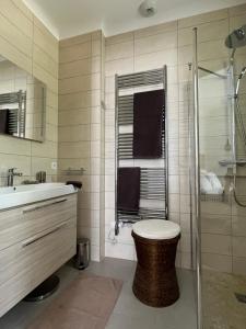 a bathroom with a toilet and a sink and a shower at Chambre villa du sentier in Pomponne +7 photos