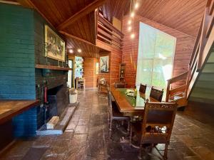 a dining room with a table and a fireplace at Forget Me Not Cottages in Warburton