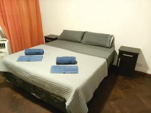 a bed with two towels on top of it at Piso García in Mendoza
