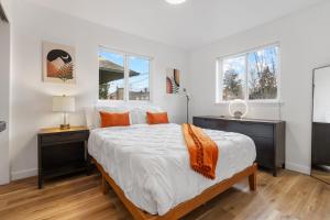 a bedroom with a large bed and two night stands at Urban Oasis with Cedar Hot Tub in Seattle