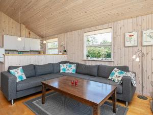 a living room with a couch and a table at Seaside Retreat in Lolland - By Traum Ferienwohnungen in Dannemare