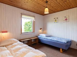 a bedroom with two beds and a window at 5 person holiday home in Roslev-By Traum in Sønder Thise