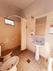 a bathroom with a toilet and a sink at La Valentina in Purmamarca