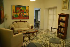 a living room with a couch and a table and chairs at Hotel Casa San Miguel Arcángel in Oaxaca City