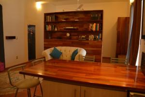 a kitchen with a table and chairs and a book shelf at Hotel Casa San Miguel Arcángel in Oaxaca City +2 photos