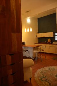 a living room and kitchen with a table and chairs at Hotel Casa San Miguel Arcángel in Oaxaca City