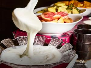 a spoonful of yogurt on a plate with a bowl of fruit at Daiwa Roynet Hotel Morioka in Morioka +56 photos
