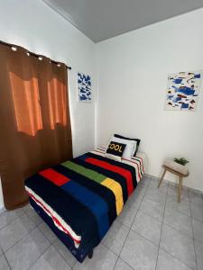 a bedroom with a bed with a colorful blanket at Casa Oriente in San Miguel