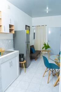 a kitchen with a refrigerator and a table and chairs at Casa Oriente in San Miguel