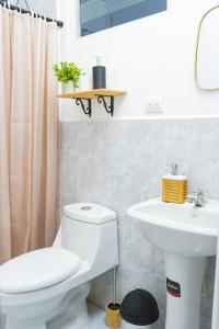 a bathroom with a toilet and a sink at Casa Oriente in San Miguel