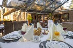 a table with plates of food and glasses of wine at AMAYA Hotel & Suites Soltau in Soltau