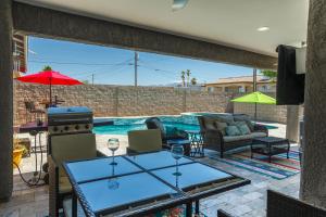 a patio with a table and chairs and a swimming pool at Coral Havasu Vacation in Lake Havasu City +16 photos