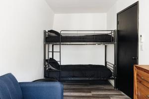 a room with two bunk beds and a blue couch at Big Bear Pine Haven Cabin Hot Tub Games in Sugarloaf