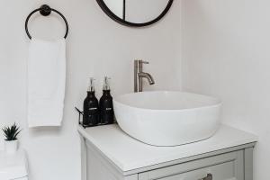 a white bathroom with a sink and a mirror at Big Bear Pine Haven Cabin Hot Tub Games in Sugarloaf +32 photos