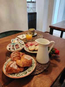 a table with plates of pastries and a jug of orange juice at Artiminus Don Baldino in Artimino