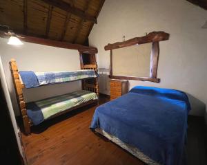 a bedroom with two bunk beds and a mirror at casa alquiler mar del plata Cabaña Acantilados MDQ in Mar del Plata +14 photos