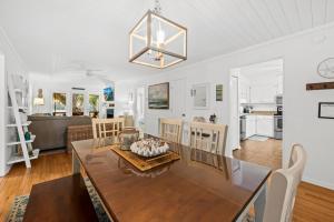 a dining room and living room with a table and chairs at 1155 Summer Wind Ln in Jupiter