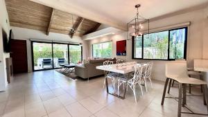 a dining room and living room with a table and chairs at Courtside Contemporary in Rancho Mirage