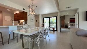 a kitchen and living room with a table and chairs at Courtside Contemporary in Rancho Mirage