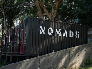 a sign for a nonyaks sign on a fence at Nomads Homestay Sriracha in Chon Buri +25 photos