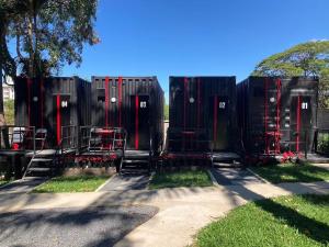 a group of black and red portable toilets at Nomads Homestay Sriracha in Chon Buri