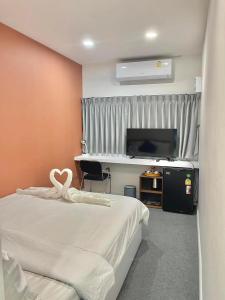 a bedroom with a bed with a heart decoration on it at Nomads Homestay Sriracha in Chon Buri