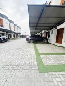 a car parked in a parking lot next to a building at 2 Bed Luxury Apartment in Lekki-Ikota Lagos in Lekki