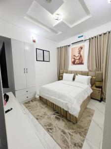 a bedroom with a bed and a tv in it at 2 Bed Luxury Apartment in Lekki-Ikota Lagos in Lekki
