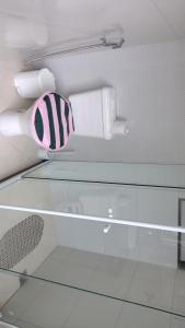 a glass shelf with a hair dryer on top of it at Cantinho da Sagrada família in São Pedro da Aldeia