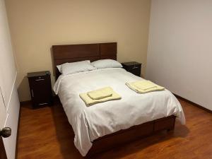 a bedroom with a bed with two towels on it at Apartments Attard in La Paz