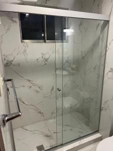 a shower with a glass door in a bathroom at Apartments Attard in La Paz
