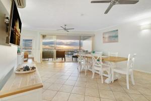 a kitchen and dining room with a table and chairs at Harbour Haven Penthouse with Marina view, Balcony and BBQ in Larrakeyah