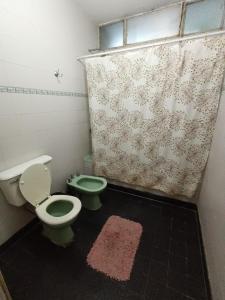 a bathroom with two toilets and a shower curtain at Casa Forum in Santiago del Estero +21 photos