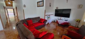 a living room with two couches and a flat screen tv at CASA CAMPESTRE Villa Carolina in San Gil