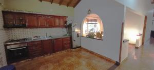a kitchen with wooden cabinets and a white refrigerator at CASA CAMPESTRE Villa Carolina in San Gil