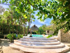 a group of steps leading to a swimming pool at Kin Resort Lodge in Maya Beach