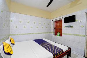 Postel nebo postele na pokoji v ubytování Hotel O Bikram Lodge