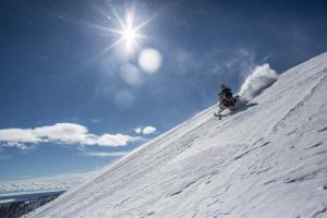 a person is skiing down a snow covered slope at Huckleberry Hollow in Rea
