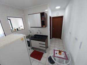a kitchen with a sink and a counter top at Lindo apto com vista mar, 200 mts da praia in Praia Grande