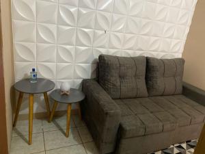 a living room with a couch and two tables at Casa da vila in Lençóis