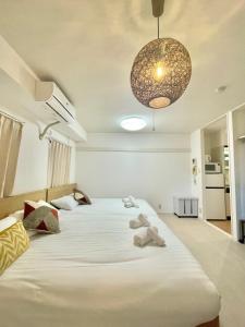 a bedroom with two beds with towels on it at YMK Oshiage 5B in Tokyo