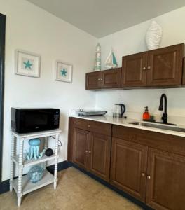 a kitchen with a sink and a microwave at Stylish 1BR Near Miami Airport & Port! in Miami +6 photos