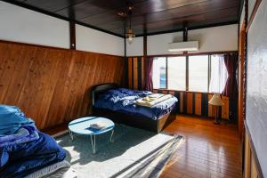 a room with two beds and a table in it at nostalgia2 ノスタルジア2 in Yokosuka