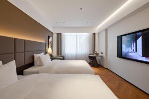 Postel nebo postele na pokoji v ubytování Panjin Xianghai Avenue Intercity Hotel + 31 fotografií